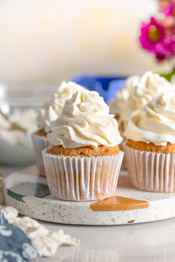cupcakes on a platter with whipped mascarpone frosting on top
