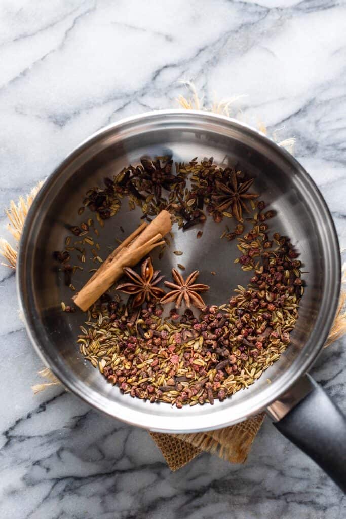 whole spices uses to make Chinese five spice in a small pan to toast