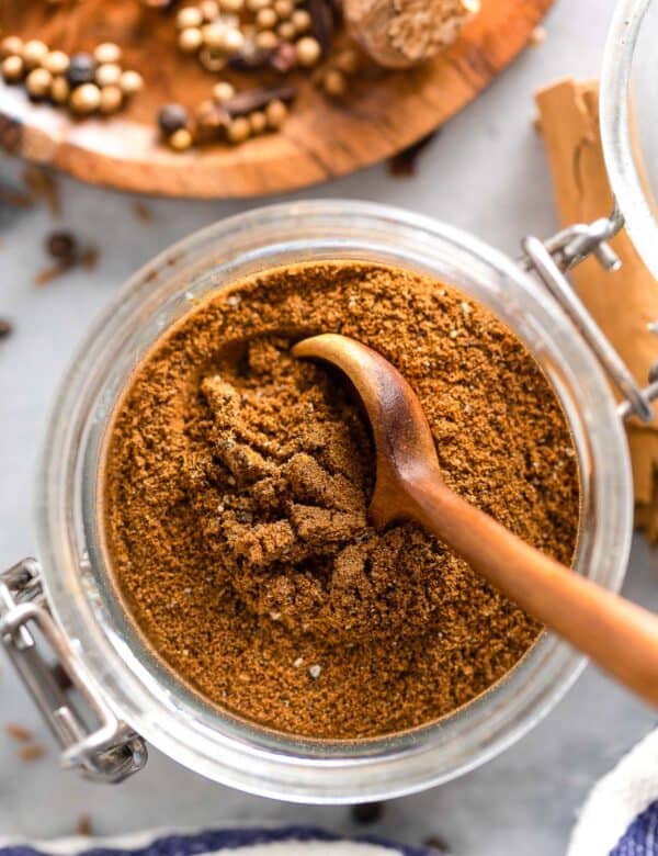 Lebanese Seven Spice in a spice jar with a spoon