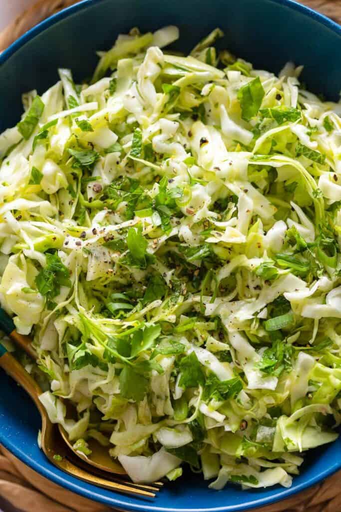 Shredded cabbage, spring onion and chopped herbs with a lemon dressing in a salad bowl (malfouf salad)