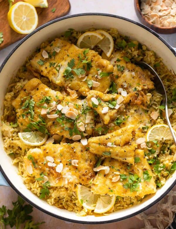 Sayadieh in a big pot - Lebanese fried Fish with Spiced Rice topped with toasted almonds and chopped parsley