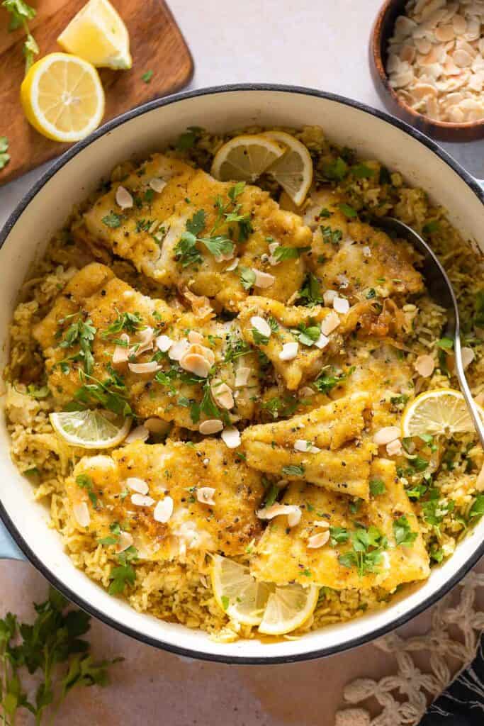 Sayadieh in a big pot - Lebanese fried Fish with Spiced Rice topped with toasted almonds and chopped parsley