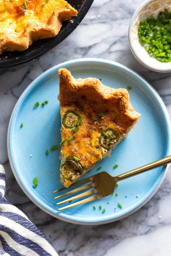 Bacon & Cheddar Jalapeño Quiche on a plate with a fork