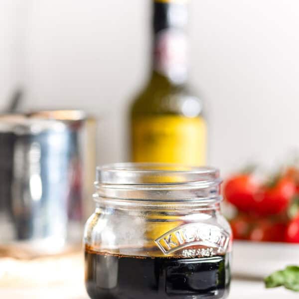 Homemade balsamic glaze in a small storage jar
