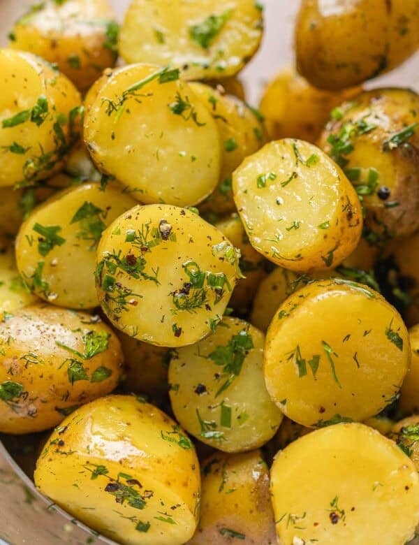 Herby Boiled Potatoes coated in black pepper, chopped fresh herbs and olive oil