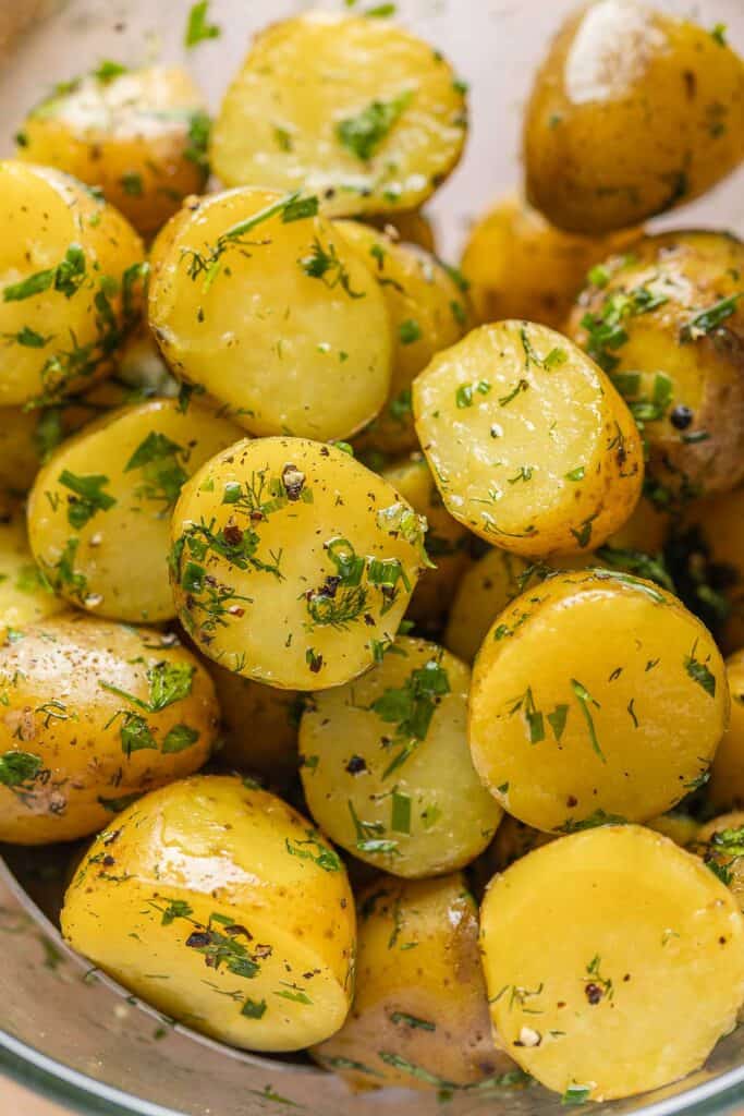 Herby Boiled Potatoes coated in black pepper, chopped fresh herbs and olive oil