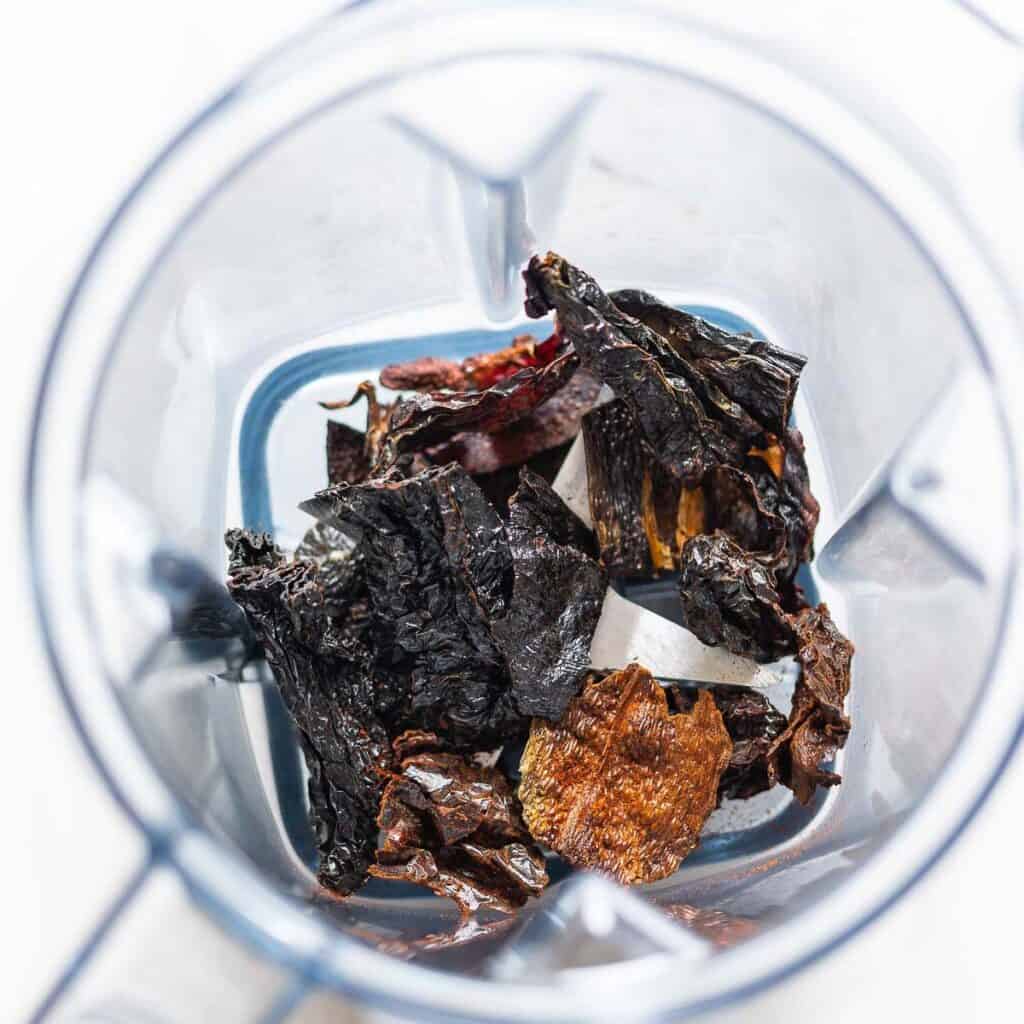 Toasted, whole, dried ancho chiles in blender.