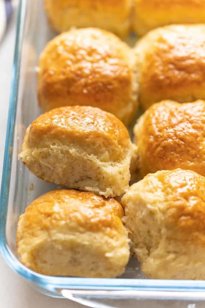 Gluten free dinner bread rolls displayed in a glass dish. 