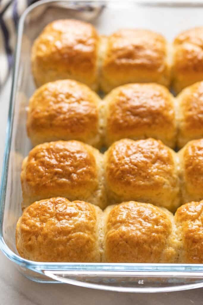 A 9x13-inch glass baking dish full of homemade gluten free dinner rolls.
