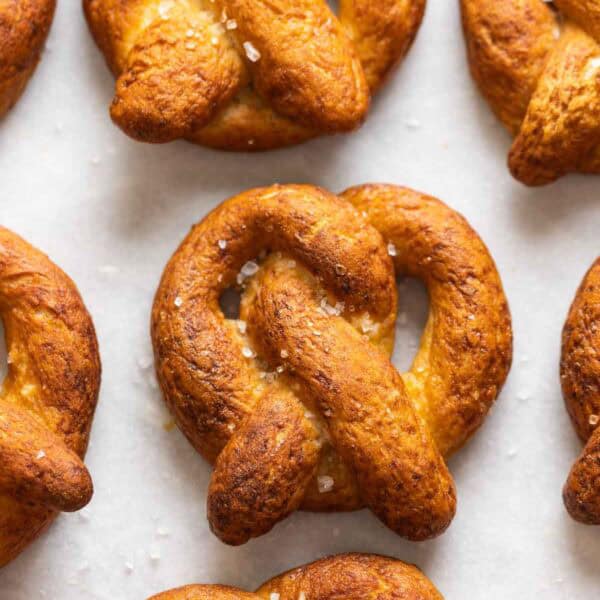 Homemade Gluten Free Soft Pretzels in rows with coarse sea salt sprinkled on top