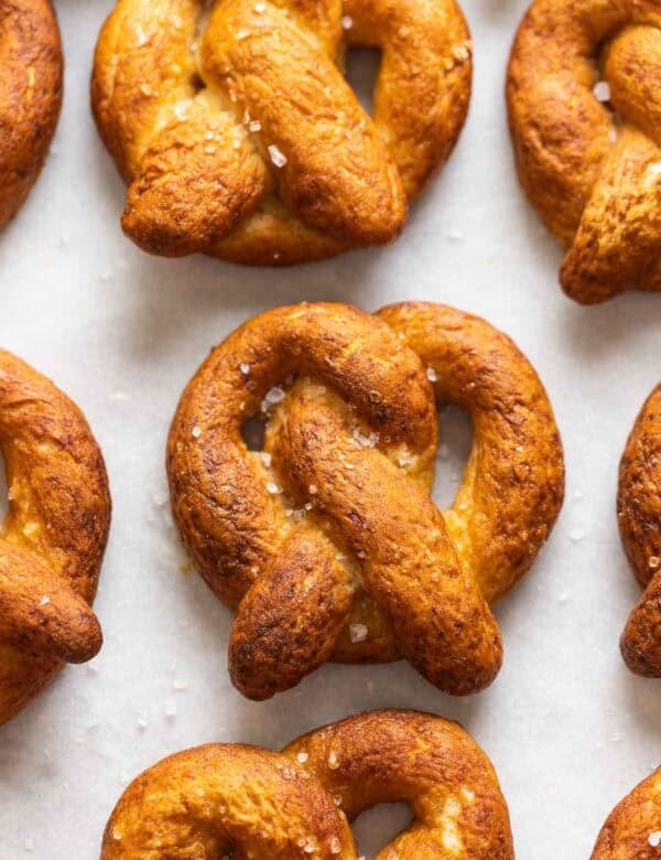 Homemade Gluten Free Soft Pretzels in rows with coarse sea salt sprinkled on top