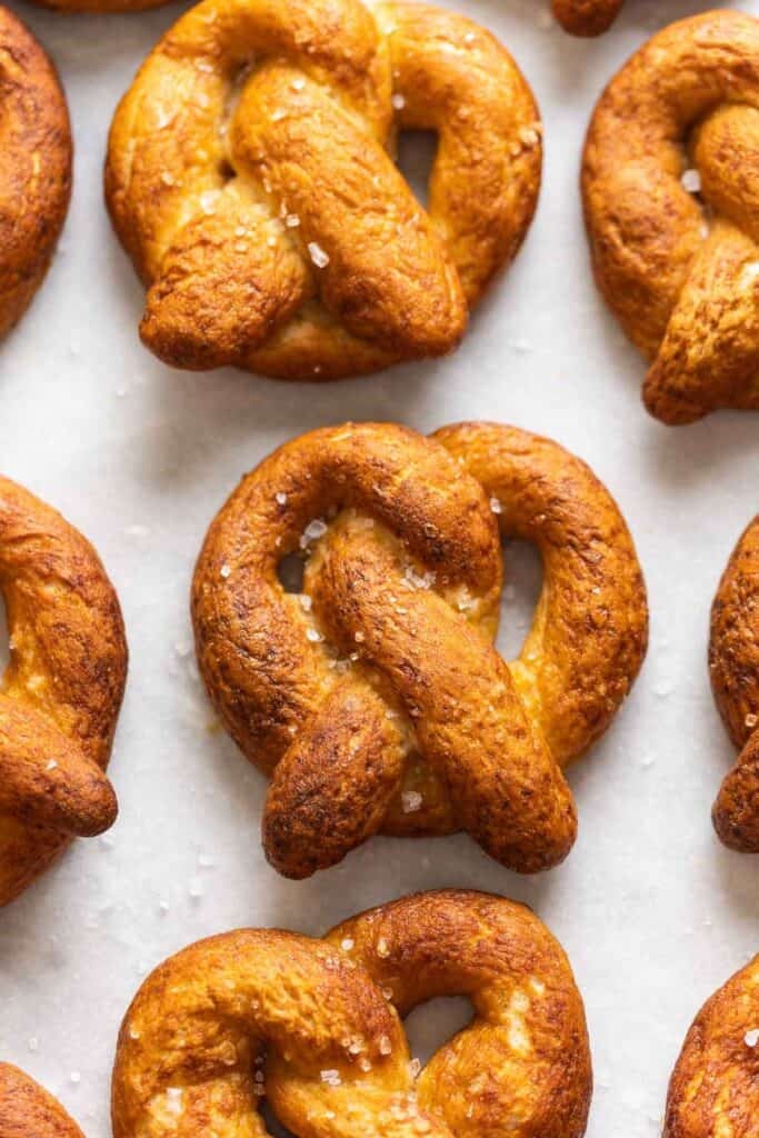 Homemade Gluten Free Soft Pretzels in rows with coarse sea salt sprinkled on top