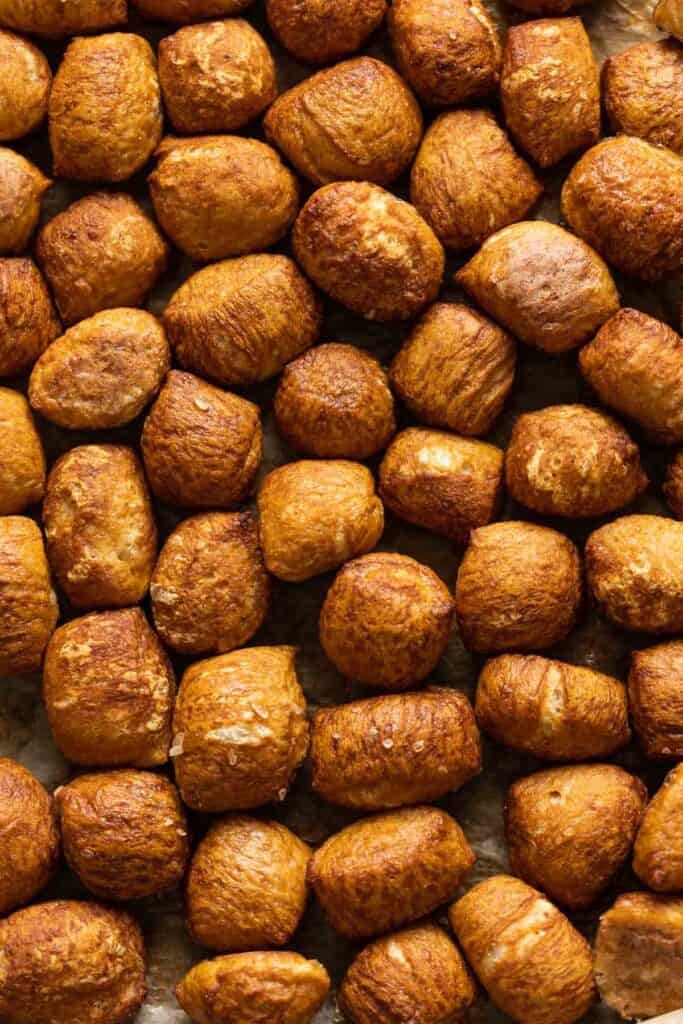 Plain gluten free pretzel bites on baking paper.