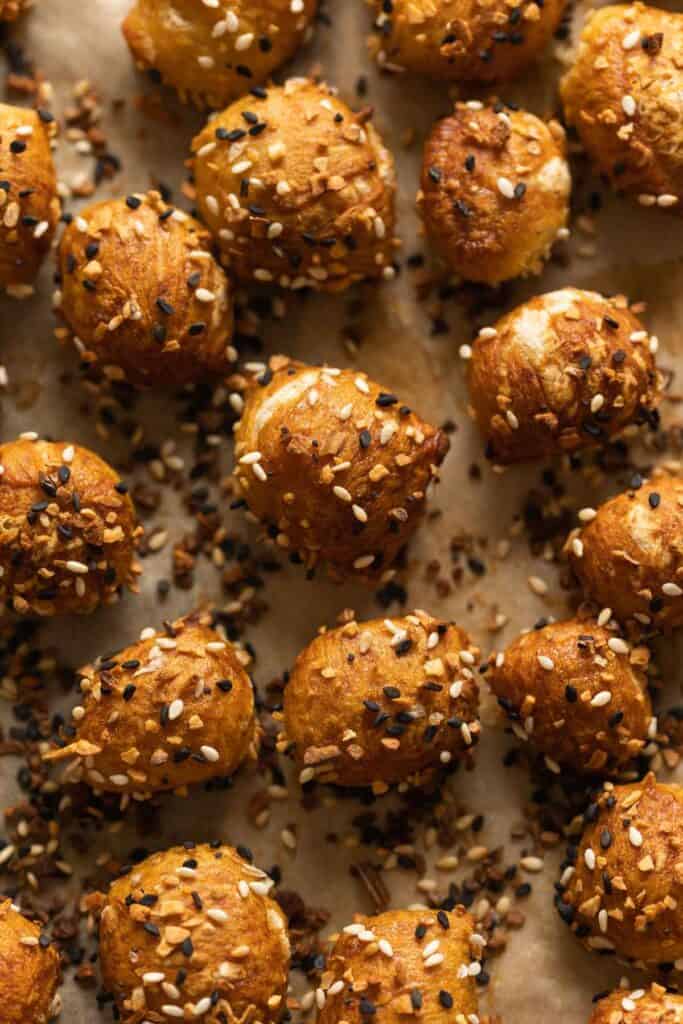 Gluten Free Pretzel Bites  covered in everything bagel seasoning on baking paper.