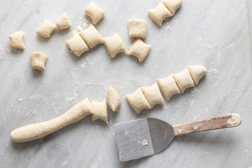Gluten free pretzel dough rolled into a long log then cut into 1-inch pieces to make pretzel bites.