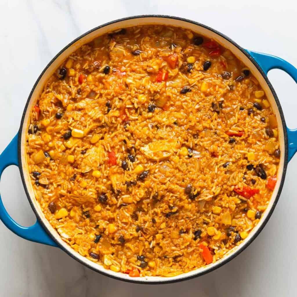 A casserole dish full of Chicken & Enchilada Rice 