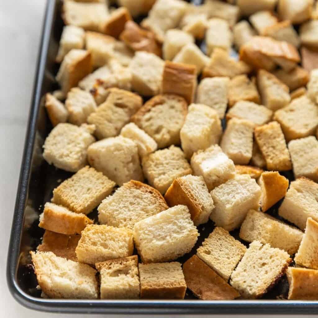 gluten free bread cubes toasted on a baking sheet until crisp