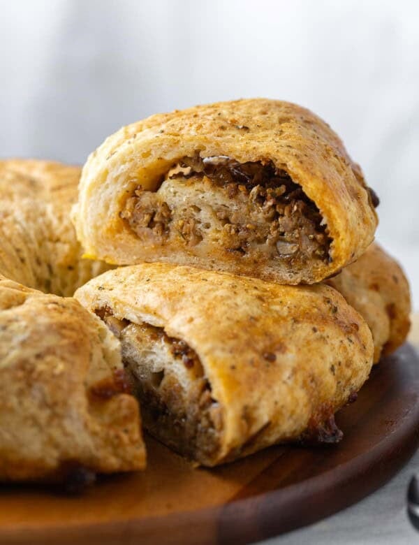 A Gluten free sausage bread slice sat on top of another slice.