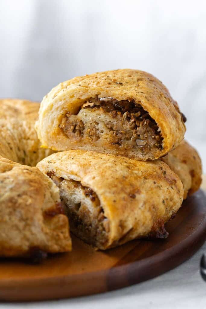 A Gluten free sausage bread slice sat on top of another slice.