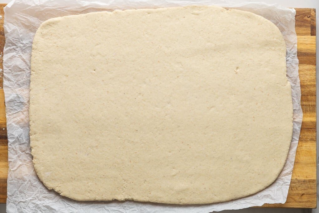 Gluten free dough rolled out into a 12-inch x 16-inch shape.