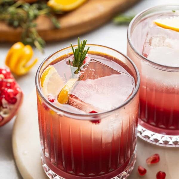 Orange Pomegranate Mocktail with fresh rosemary, orange slices and arils