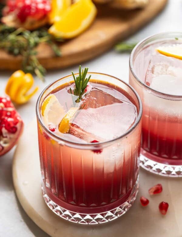 Orange Pomegranate Mocktail with fresh rosemary, orange slices and arils