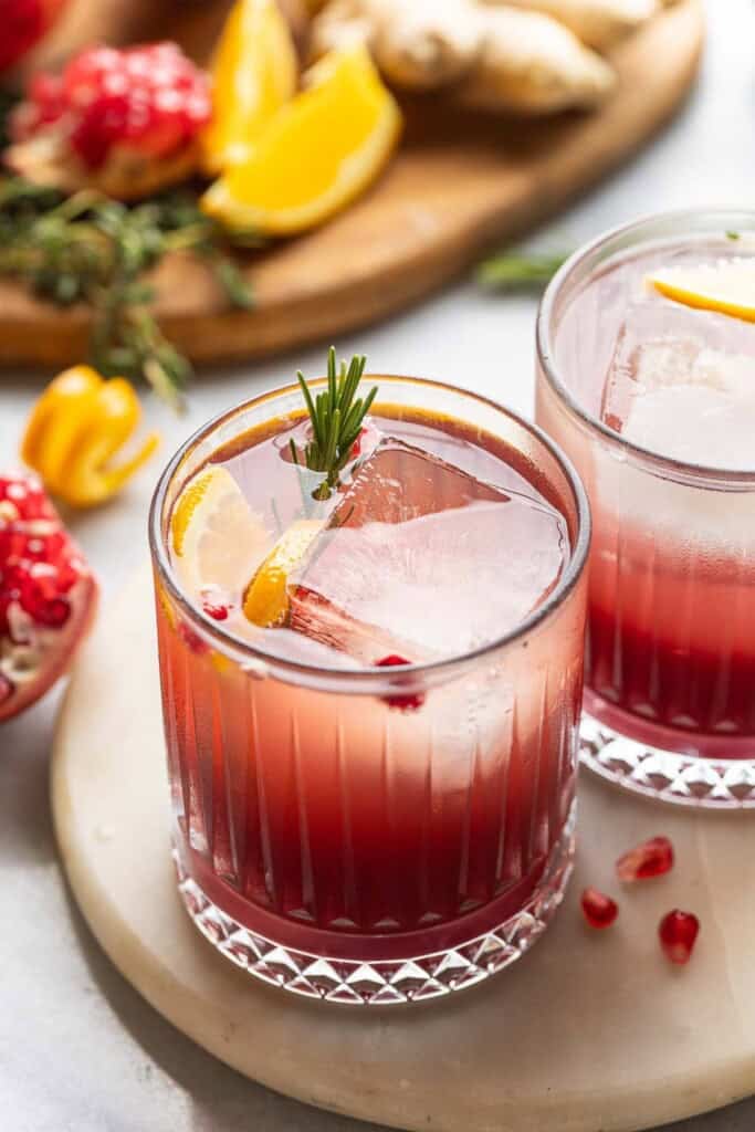 Orange Pomegranate Mocktail with fresh rosemary, orange slices and arils