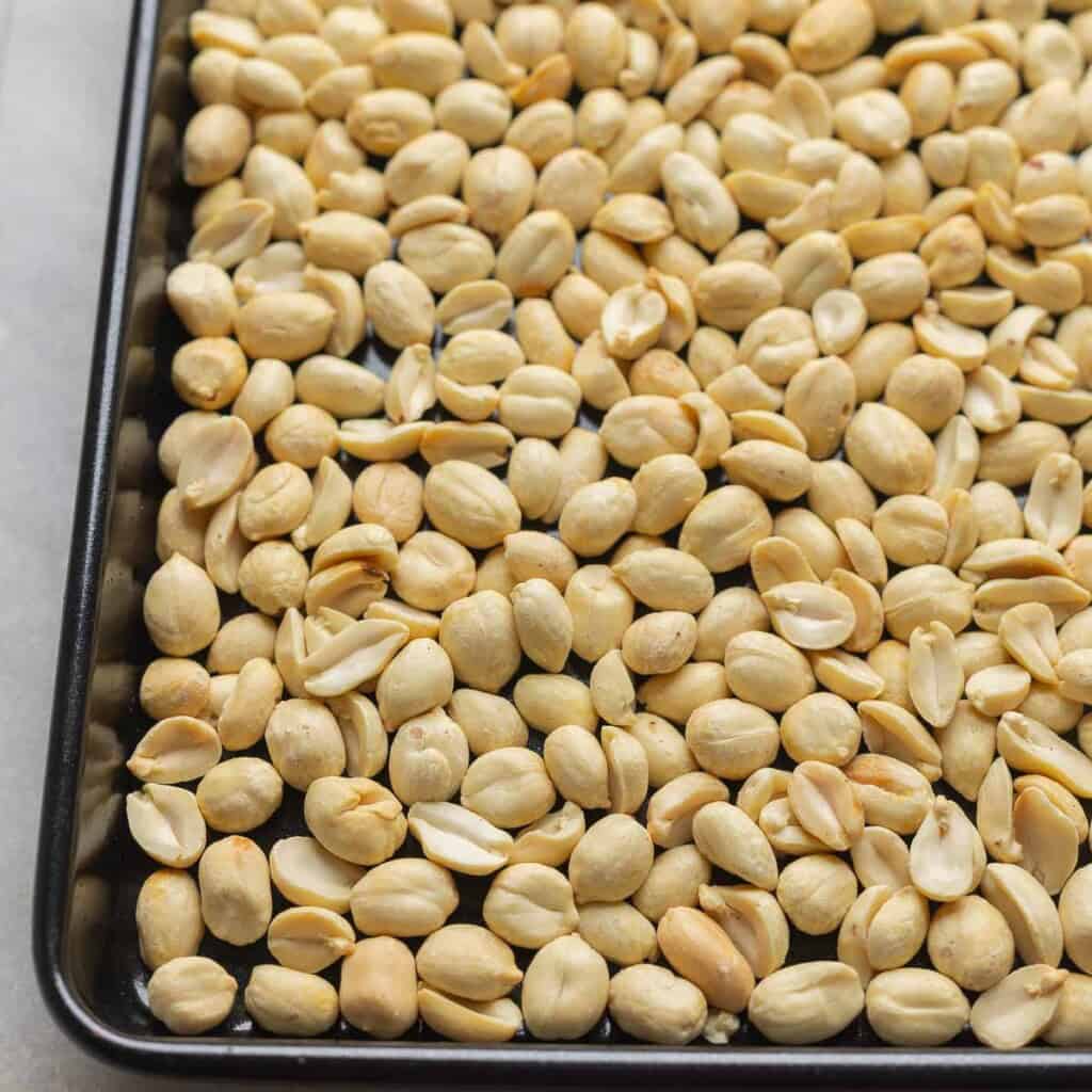 Lightly roasted peanuts on a baking sheet