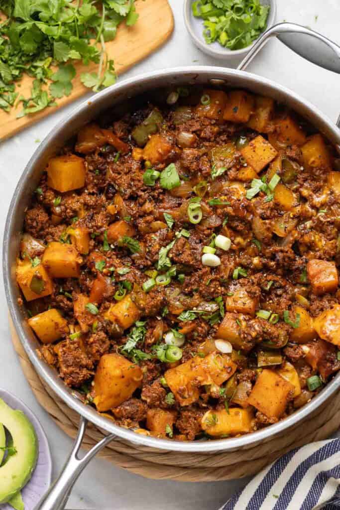 Ground Beef & Potatoes Skillet with spring onions and cilantro on top