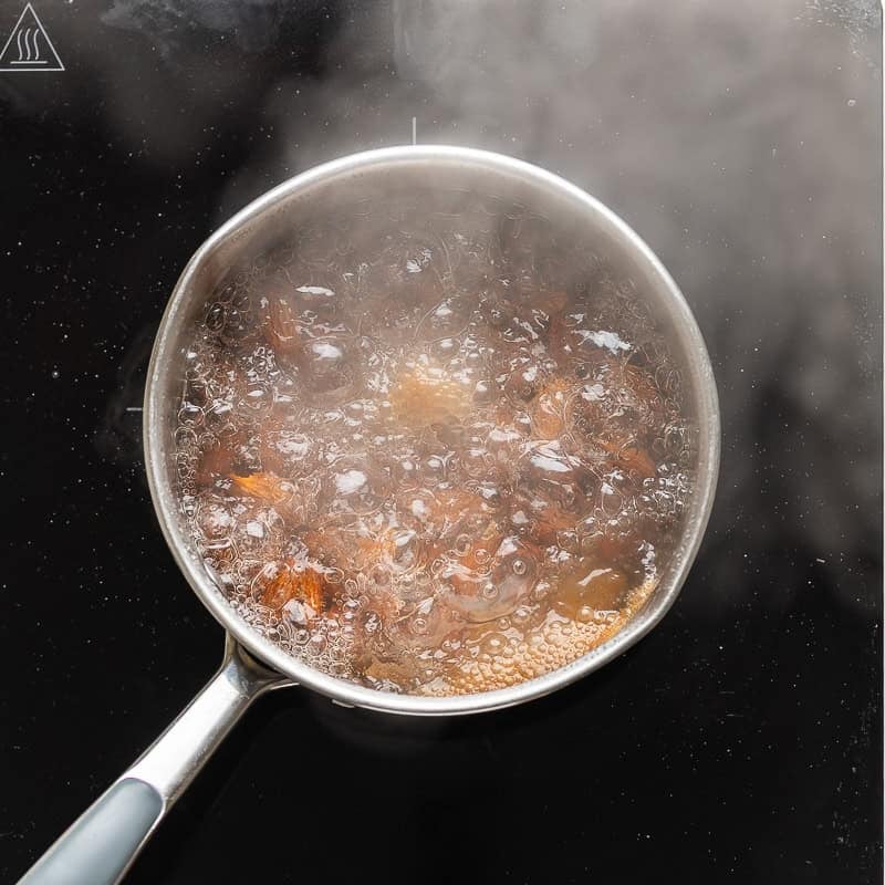 A pot of almonds boiling in water
