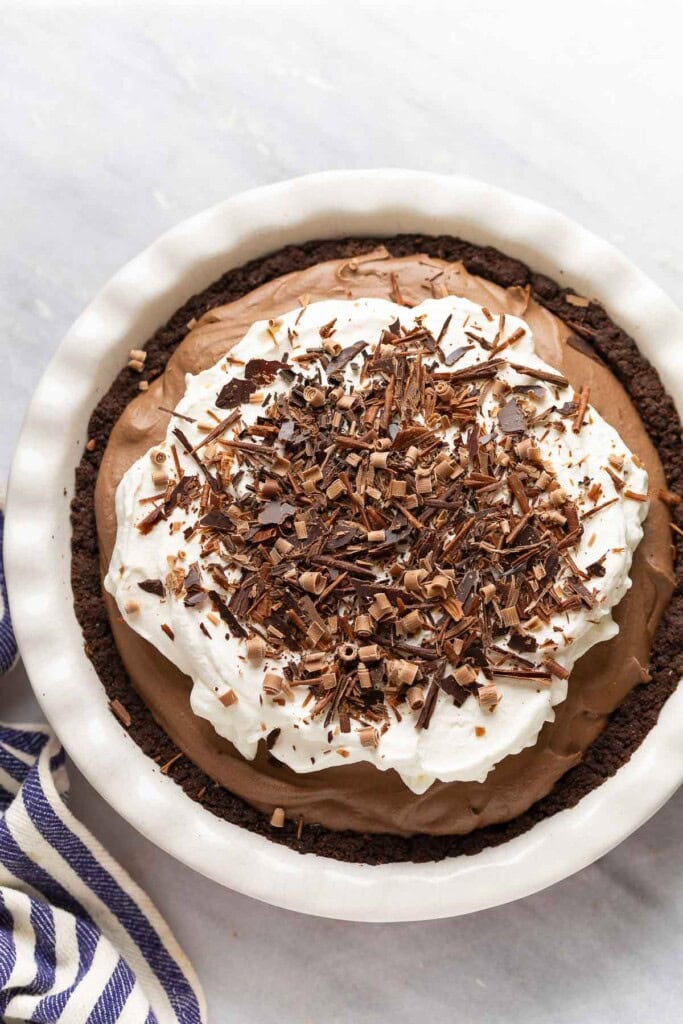 gluten free french silk pie with a chocolate cookie crust topped with chocolate shavings