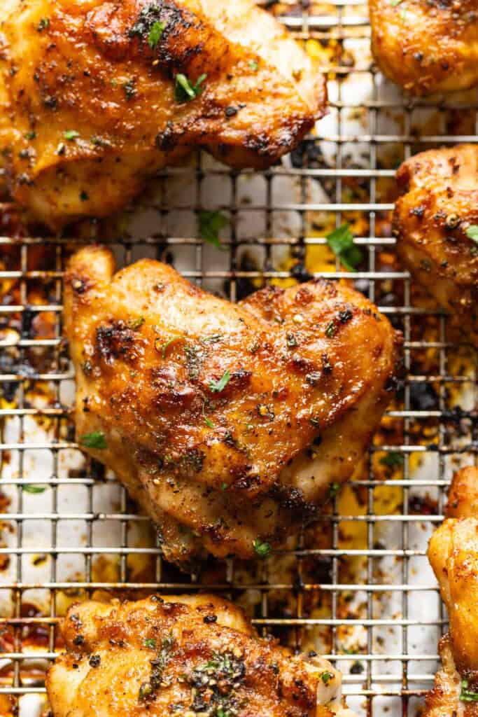 Lemon Pepper Chicken Thighs on a wire cooking rack