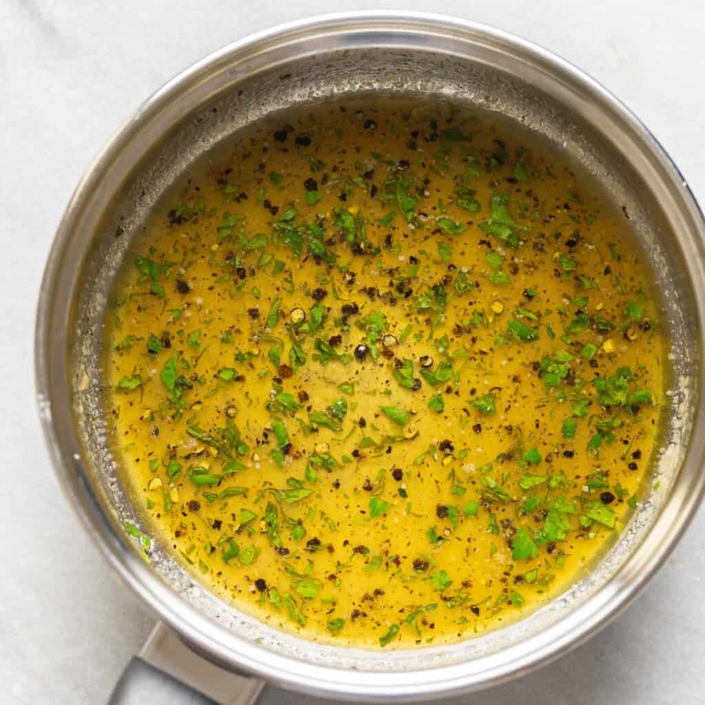 Lemon pepper herb sauce in a small sauce pan.
