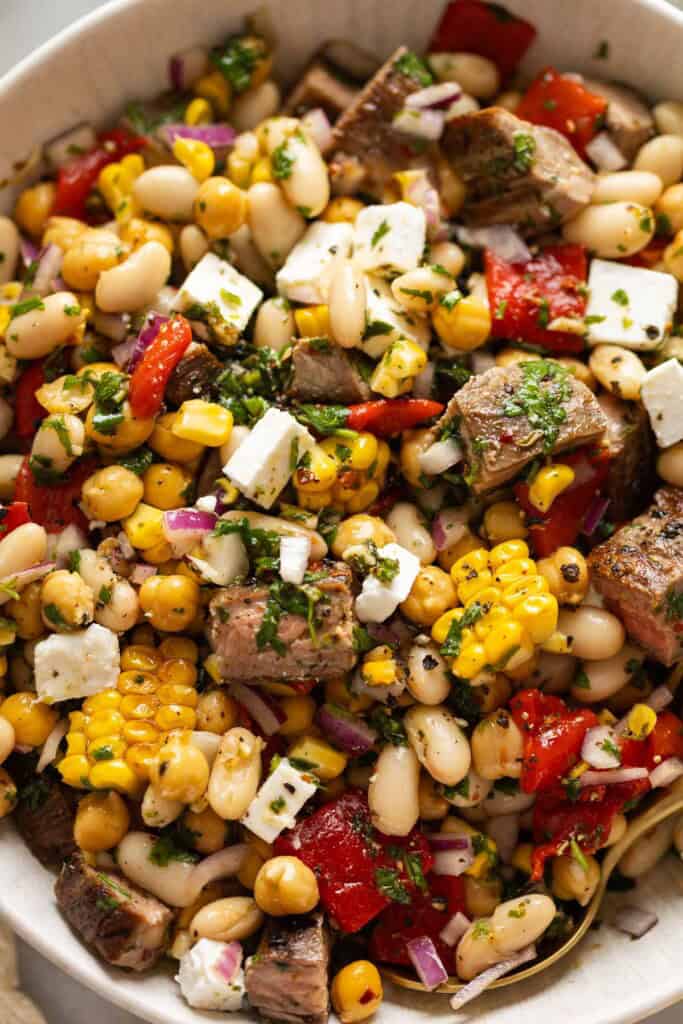 Chimichurri Dense Bean Steak Salad with steak bites, corn, roasted red pepper, onion and beans