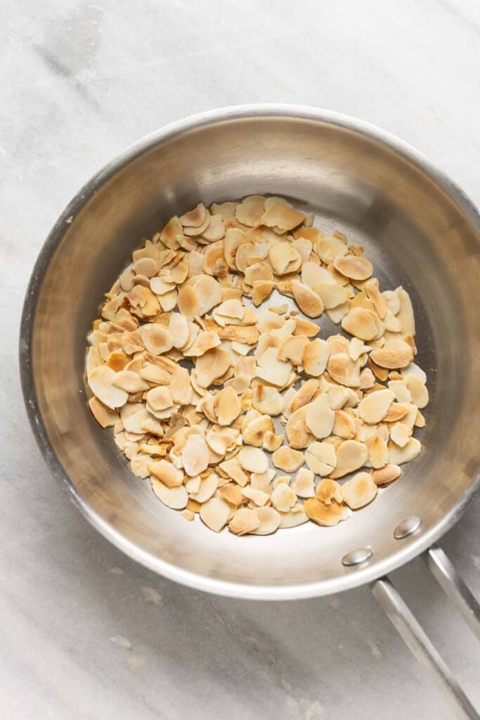 Toasted, sliced almonds in a small frying pan