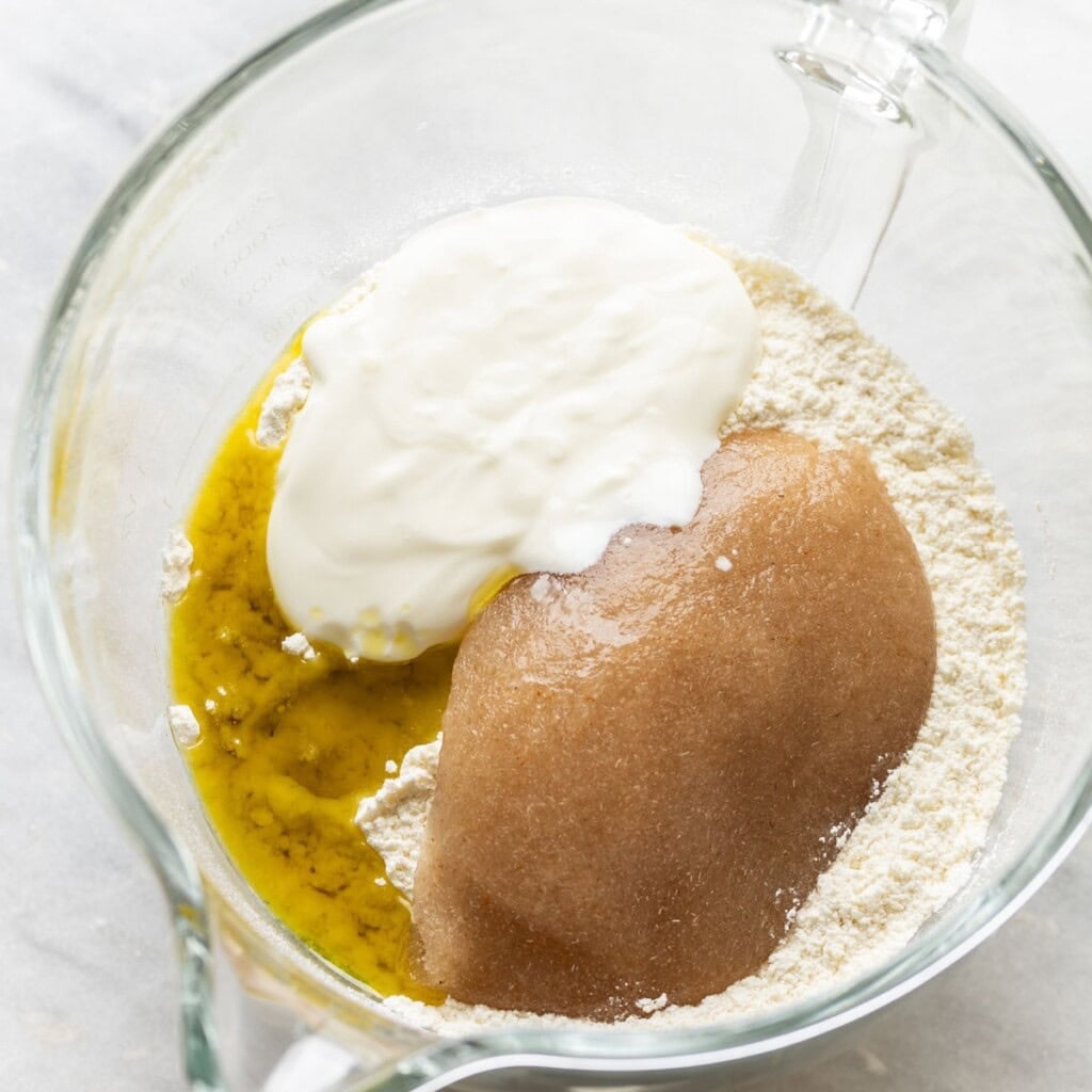 Psyllium gel, greek yoghurt & oil added to a bowl of a gluten free flour mixture