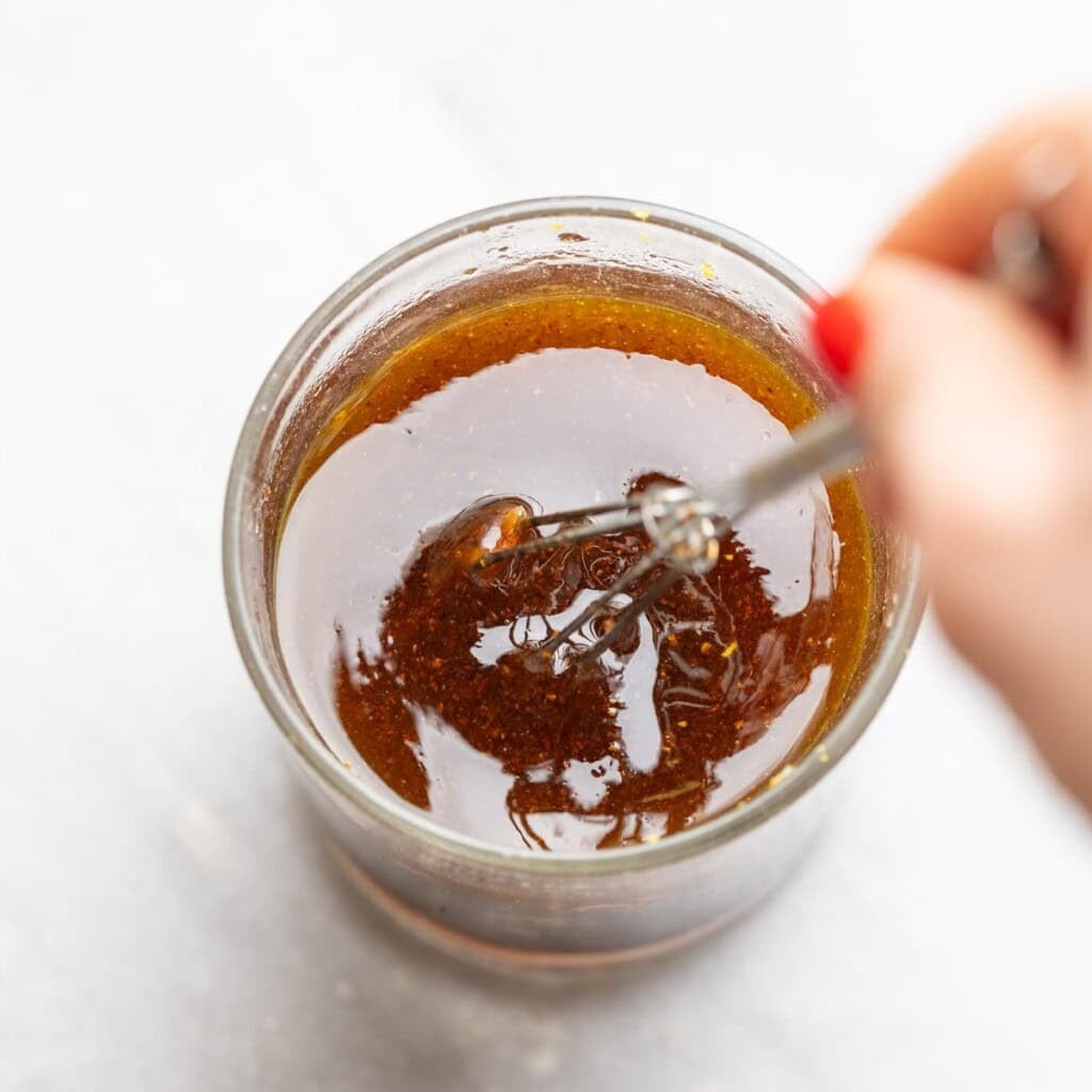 vinaigrette for a fattoush salad mixing together in a small cup