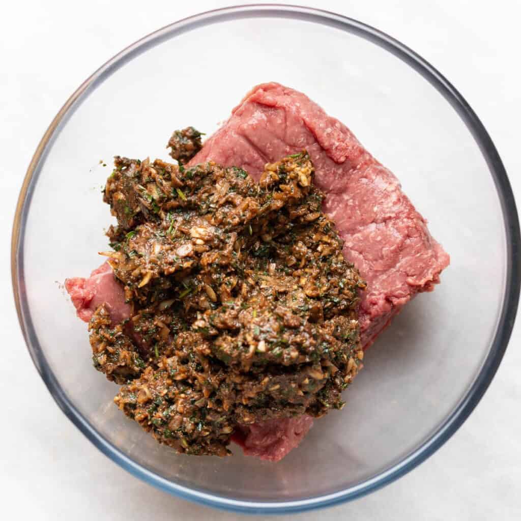 Beef minces and Blended up onion, garlic, parsley, spices, tomato paste and pomegranate molasses in a mixing bowl