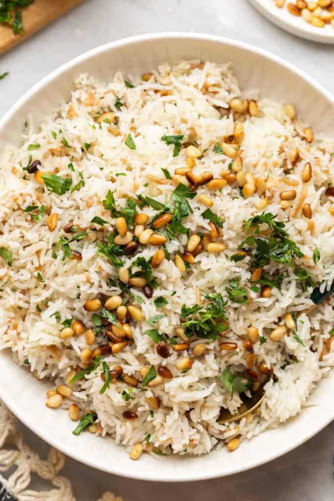 Lebanese rice made with gluten free noodles, toasted pine nuts and fresh chopped parsley in a serving dish