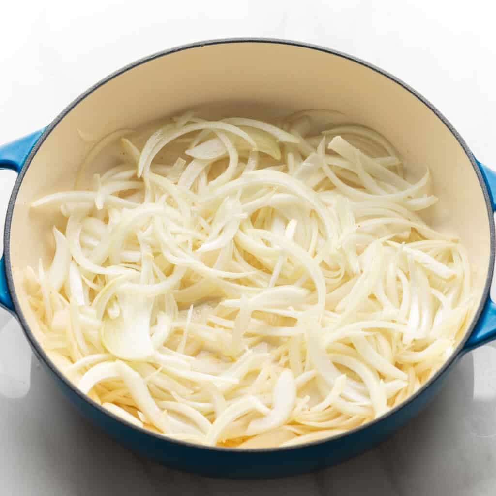 two large sliced onions in a casserole dish