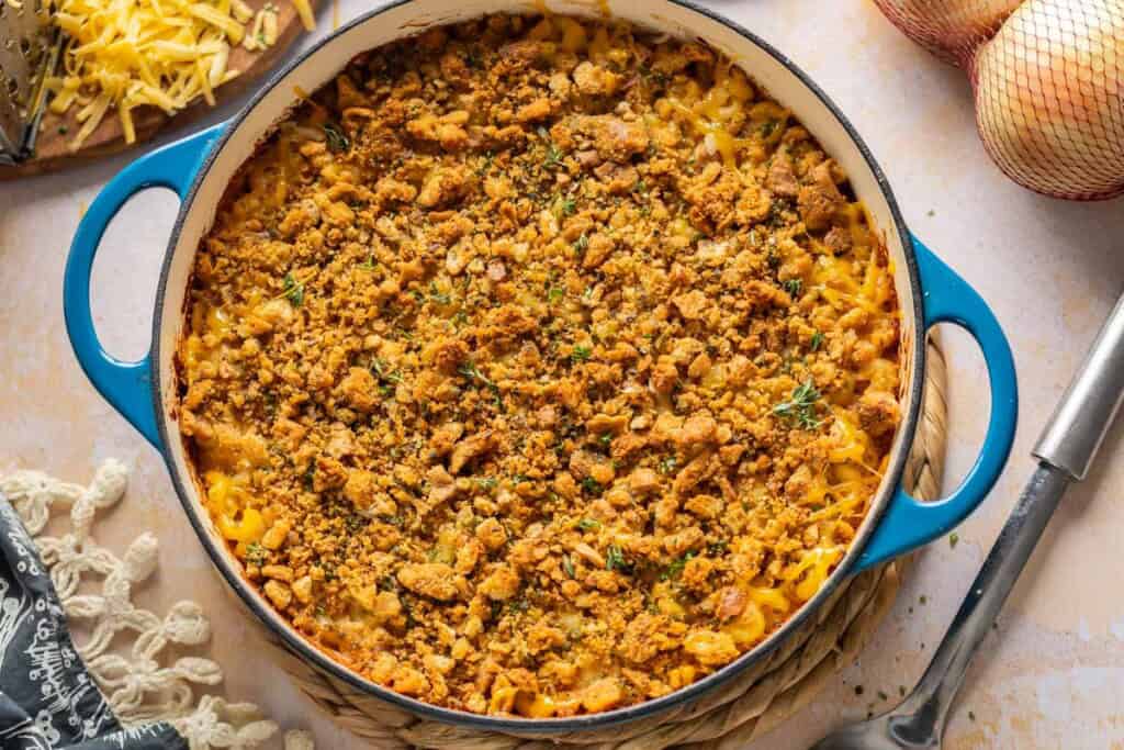 Hard cider caramelized onion & bacon mac and cheese in a casserole dish topped with seasoned breadcrumbs
