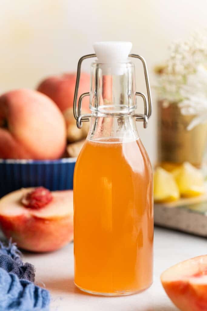 A bottle of homemade peach syrup