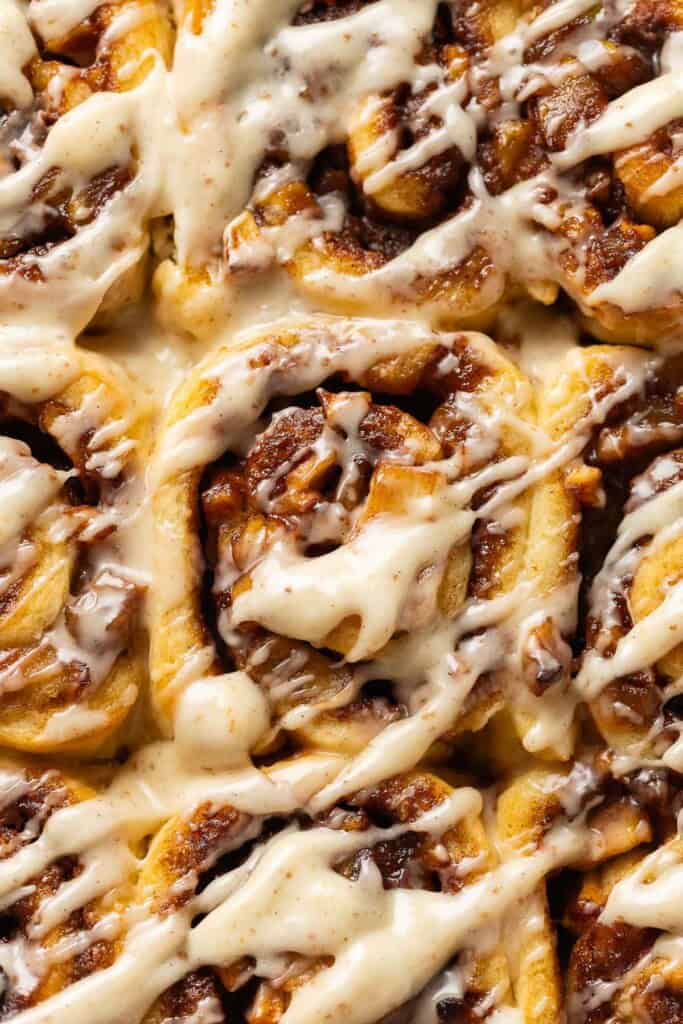 Gluten Free Apple Cinnamon Rolls with a brown butter cream cheese frosting drizzled over top